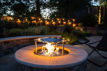 Load image into Gallery viewer, HeatSaver fire pit heat deflector and cover in a backyard setting with lights