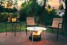 Load image into Gallery viewer, HeatSaver fire pit heat deflector and cover positioned on a deck
